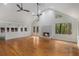 Bright living room with hardwood floors, a fireplace, and French doors leading to the backyard at 535 Emerald Pkwy, Sugar Hill, GA 30518