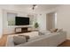 Inviting living room with large screen television, comfortable sectional, and natural light at 535 Emerald Pkwy, Sugar Hill, GA 30518