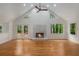 Spacious living room boasts a fireplace, wood floors, and backyard views at 535 Emerald Pkwy, Sugar Hill, GA 30518
