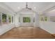 Spacious living room boasts a bay window overlooking a wooded yard and luxury vinyl plank flooring at 535 Emerald Pkwy, Sugar Hill, GA 30518