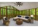 Cozy screened-in porch with tiled floors and modern furniture offers wooded views and relaxation at 535 Emerald Pkwy, Sugar Hill, GA 30518