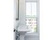 Pedestal sink in a bathroom with a big window bringing natural light at 105 Iveybrooke Ln # 57, Alpharetta, GA 30009