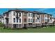 A view of the exterior facade of the townhome featuring well maintained landscaping at 105 Iveybrooke Ln # 57, Alpharetta, GA 30009