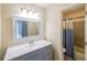 Well-lit bathroom featuring modern vanity, decorative mirror, and shower/tub combination at 1206 Canyon Point Cir, Roswell, GA 30076