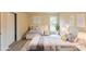 Sunlit bedroom with two twin beds, neutral tones, and serene decor offers a cozy retreat at 1206 Canyon Point Cir, Roswell, GA 30076