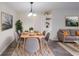 Bright dining room features a modern chandelier, seating for six, and stylish gray and wood accents at 1206 Canyon Point Cir, Roswell, GA 30076