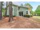 Exterior view of a two-story home with mature trees and landscaping at 1206 Canyon Point Cir, Roswell, GA 30076