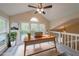 Bright home office featuring large windows, a ceiling fan, and modern desk area at 1206 Canyon Point Cir, Roswell, GA 30076