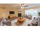 Cozy living room features a fireplace, comfortable seating, and bright natural light at 1206 Canyon Point Cir, Roswell, GA 30076