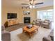 Spacious living room with fireplace, ceiling fan, and plush rug, perfect for relaxing and entertaining at 1206 Canyon Point Cir, Roswell, GA 30076