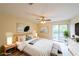Spacious main bedroom with a ceiling fan, walk-out balcony, and large closet at 1206 Canyon Point Cir, Roswell, GA 30076