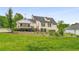 Back exterior view of a home with a spacious yard and deck at 1320 Pinyon Pl, Lawrenceville, GA 30043
