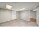 Spacious basement area featuring neutral carpeting and an access door at 1320 Pinyon Pl, Lawrenceville, GA 30043