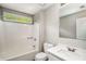 Bathroom with combination tub and shower, white vanity, and mirror providing a bright and functional space at 1320 Pinyon Pl, Lawrenceville, GA 30043