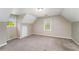 Attic bedroom with neutral walls, carpet, and two windows providing natural light, and unique architecture at 1320 Pinyon Pl, Lawrenceville, GA 30043