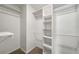 Walk-in closet with shelving units and carpeted floor providing ample space for storage and organization at 1320 Pinyon Pl, Lawrenceville, GA 30043