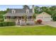 Charming home with a brick facade, a cozy front porch, and a two-car garage at 1320 Pinyon Pl, Lawrenceville, GA 30043