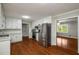 Modern kitchen featuring stainless steel appliances, white cabinets, and open layout for easy entertaining at 1320 Pinyon Pl, Lawrenceville, GA 30043