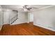 Open living room featuring gleaming hardwood floors, neutral walls and a staircase at 1320 Pinyon Pl, Lawrenceville, GA 30043