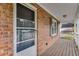 Covered porch featuring a brick exterior and providing a cozy entryway into the home at 1320 Pinyon Pl, Lawrenceville, GA 30043