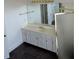 Bathroom with a large mirror above a double sink vanity with white cabinets at 240 Flowers Cove Ln, Lilburn, GA 30047