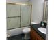 Bathroom with a granite vanity and a frosted glass shower door at 240 Flowers Cove Ln, Lilburn, GA 30047