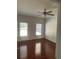 Bedroom with hardwood floors and two windows at 240 Flowers Cove Ln, Lilburn, GA 30047