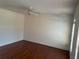 Bedroom with hardwood floors, ceiling fan, and a window allowing natural light at 240 Flowers Cove Ln, Lilburn, GA 30047