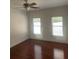 Bedroom with hardwood floors and two windows at 240 Flowers Cove Ln, Lilburn, GA 30047