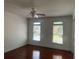 Bedroom featuring hardwood floors, ceiling fan, and two windows at 240 Flowers Cove Ln, Lilburn, GA 30047
