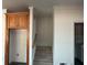 A hallway featuring stairs to the basement and wooden cabinets at 240 Flowers Cove Ln, Lilburn, GA 30047