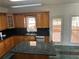 Spacious kitchen with wood cabinets, granite counters, and stainless appliances at 240 Flowers Cove Ln, Lilburn, GA 30047