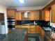 Kitchen featuring wooden cabinets, granite counters, and stainless steel appliances at 240 Flowers Cove Ln, Lilburn, GA 30047