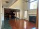 Open-concept living room with hardwood floors, fireplace and an adjacent kitchen at 240 Flowers Cove Ln, Lilburn, GA 30047