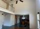 Spacious living room with a two-story ceiling, view of the kitchen and a balcony at 240 Flowers Cove Ln, Lilburn, GA 30047