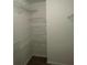 An open walk-in closet with metal shelving at 240 Flowers Cove Ln, Lilburn, GA 30047