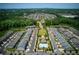 Expansive aerial view of a residential community featuring orderly streets, green spaces, and a serene pond at 1074 Heyward Way, Alpharetta, GA 30009