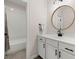 Classic bathroom featuring white subway tile in the shower, modern fixtures, and a round mirror at 1074 Heyward Way, Alpharetta, GA 30009