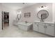 Elegant bathroom features a soaking tub, double vanities, and a spacious walk-in closet for ample storage at 1074 Heyward Way, Alpharetta, GA 30009