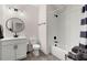 Modern bathroom featuring white subway tile shower, matte black fixtures, and stylish round mirror at 1074 Heyward Way, Alpharetta, GA 30009