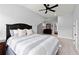 Bright bedroom showcasing a large bed, ceiling fan, and doorway to an adjacent space at 1074 Heyward Way, Alpharetta, GA 30009