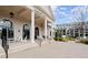 Spacious Clubhouse porch features white rocking chairs, tables, and manicured landscaping at 1074 Heyward Way, Alpharetta, GA 30009