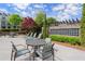 Relax in this outdoor community space with comfortable seating and beautiful landscaping at 1074 Heyward Way, Alpharetta, GA 30009