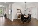 Elegant dining room featuring hardwood floors, stylish lighting fixture, and ample space for entertaining at 1074 Heyward Way, Alpharetta, GA 30009
