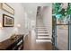 Warm and inviting entryway featuring hardwood floors, staircase, and tasteful decor at 1074 Heyward Way, Alpharetta, GA 30009
