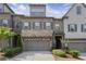 Charming townhome with a stone and brick facade, inviting curb appeal, and a two-car garage at 1074 Heyward Way, Alpharetta, GA 30009