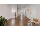 Hallway features hardwood floors, white trim, and staircase at 1074 Heyward Way, Alpharetta, GA 30009