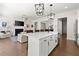 Bright open kitchen with a large island, pendant lighting, stainless steel appliances, and hardwood flooring at 1074 Heyward Way, Alpharetta, GA 30009