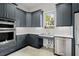 Modern kitchen features stainless steel appliances and gray cabinets for a sleek look at 1074 Heyward Way, Alpharetta, GA 30009