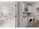 Convenient laundry room located adjacent to the bathroom features modern appliances and ample storage at 1074 Heyward Way, Alpharetta, GA 30009